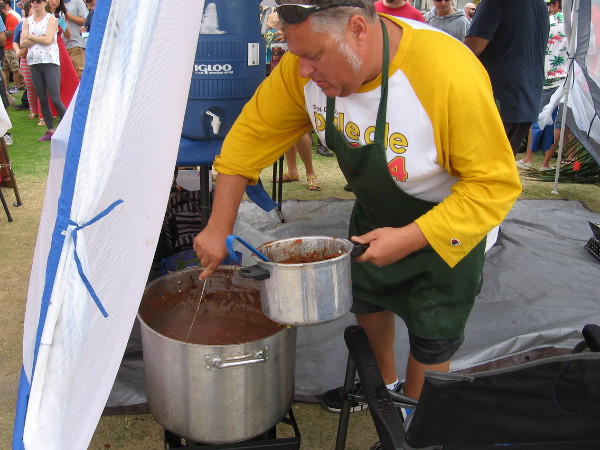 Stirring and scooping from one big pot of hot chili!