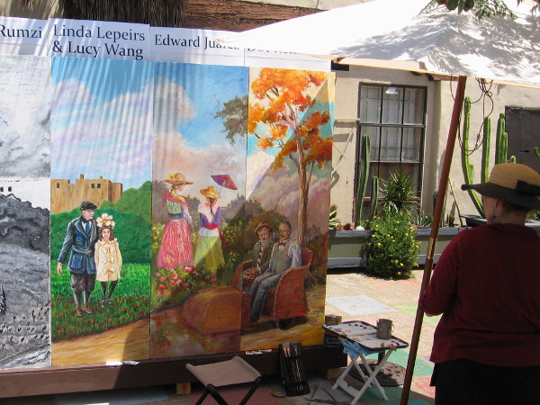 Artist studies the right end of the 20 foot long mural. That golden tree looks like it could be transplanted right into Spanish Village!