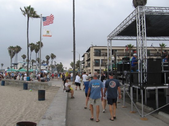 People walk behind the Main Stage along the beach, toward the Ocean Beach lifeguard station. An overcast day with a few sprinkles, but it didn't matter!