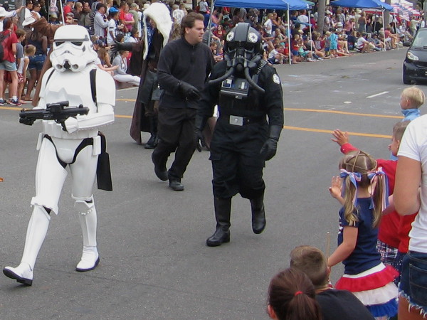 Kids wave at Star Wars stormtrooper and tie fighter pilot at the Coronado Independence Day parade!