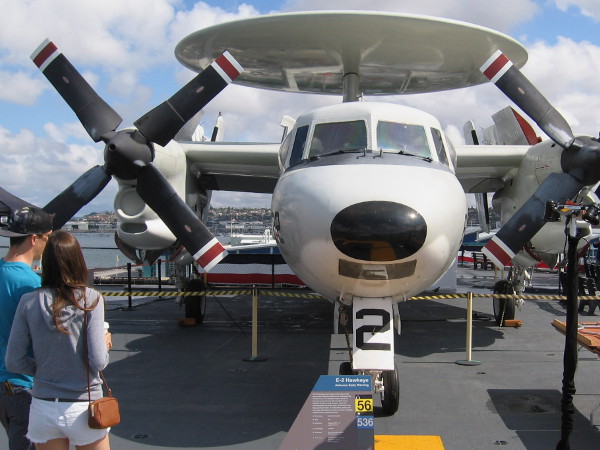 Young couple takes a look at E-2 Hawkeye, an Airborne Early Warning aircraft.