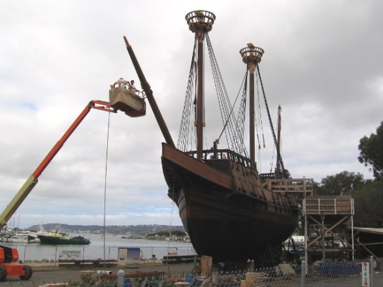 Maritime Museum of San Diego volunteers work on the bowsprit, before San Salvador is eventually moved onto a barge, then hoisted at a local shipyard into the bay.