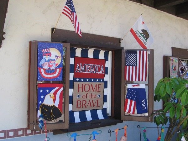 Window at Alamo Flags in Seaport Village has patriotic displays. Mike Ismail, the owner, is proud and grateful to be a free American.