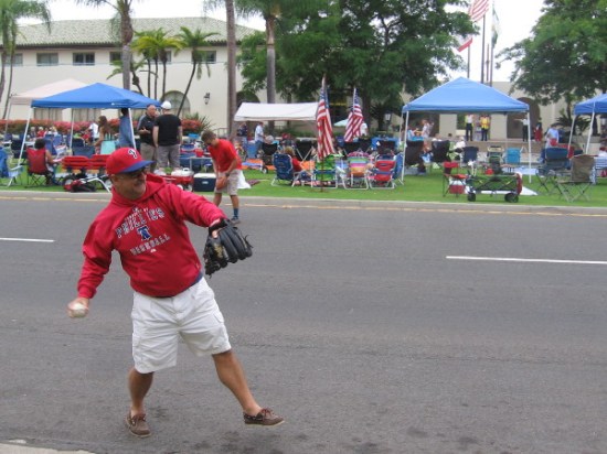What could be more American than tossing a baseball while waiting for the big parade to begin.