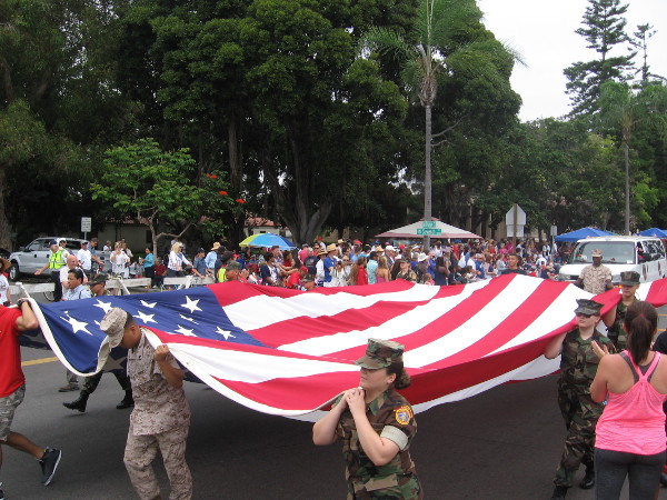 San Diego heroes carry a large American flag.