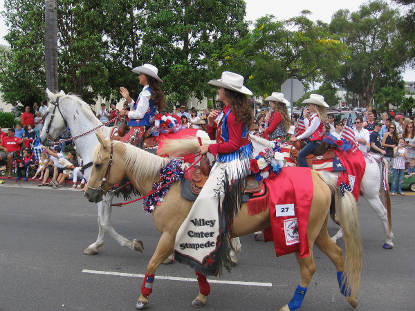 Here come the Valley Center Rodeo Queens on horseback.