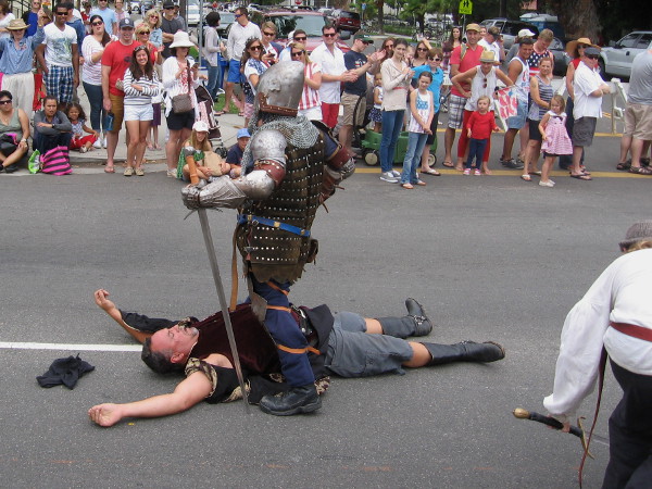 Some medieval knights did battle on the parade route. Seems one has emerged the victor.