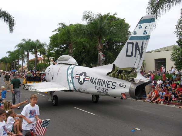 Historic fighter jet heads down Orange Avenue as Fourth of July parade onlookers honor the troops.