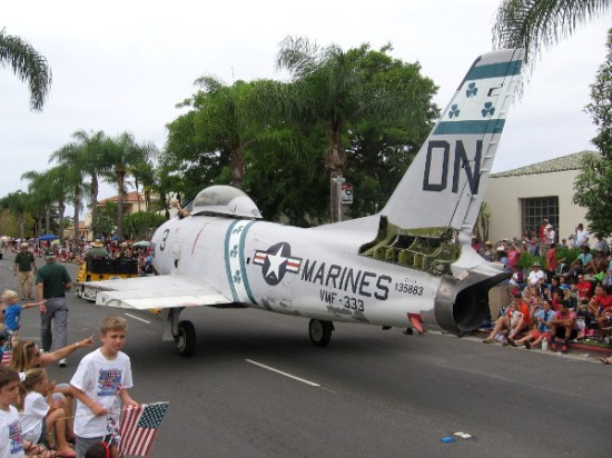 Historic fighter jet heads down Orange Avenue as Fourth of July parade onlookers honor the troops.