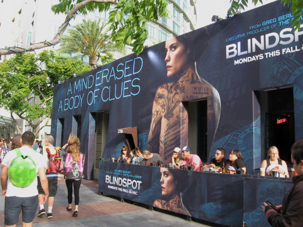 People dine at the Tin Fish, which is completely wrapped in NBC Blindspot graphics. A mind erased. A body of clues.