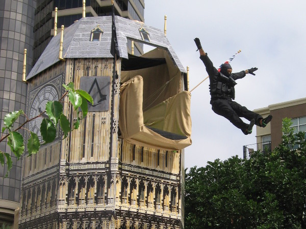 Cosplay ninja takes a flying plunge from the top of the clock tower at Assassin's Creed obstacle course.