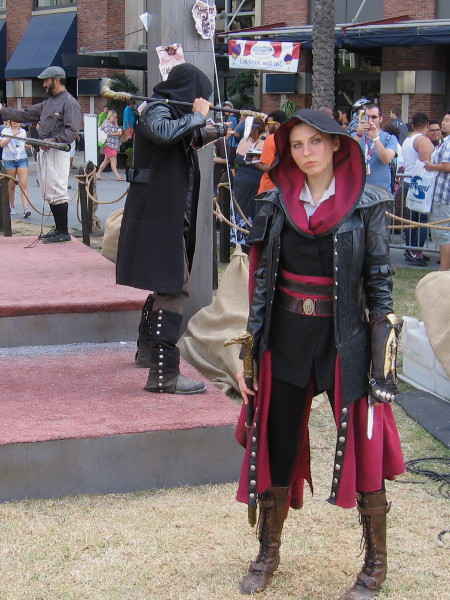 A hooded lady assassin gives me a calculating stare from the Ubisoft Assassin's Creed obstacle course.