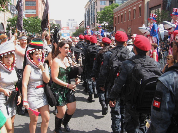 The Colony troop files past shark head-wearing Sharknado 3 girls and an Outlander bagpiper! It's complete mayhem.