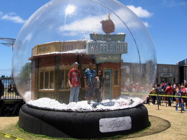 Fargo fans stand in a glitter-filled huge snow globe for a photograph!