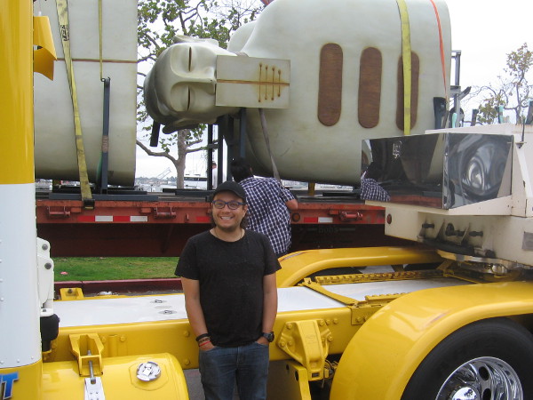 Rivelino smiles broadly as he supervises the movement of his monumental works of art!