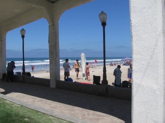 Youth and a surfboard just north of the pier. It's another perfect sunny weekend in Southern California.