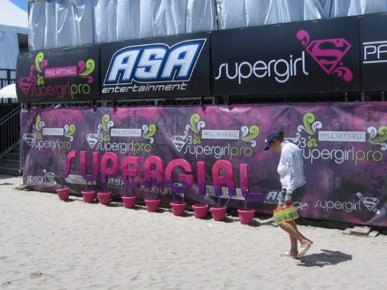 Someone walks past the Supergirl Pro staging tent, where contestants assemble and get ready to compete.