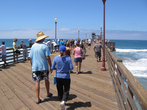 Walking farther out on Oceanside Pier to get closer to the powerful Pacific Ocean breakers.