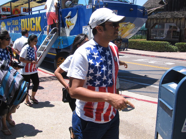 Tourists wearing Old Glory have disembarked from a San Diego SEAL Tours cool Hydra-Terra vehicle at Seaport Village.