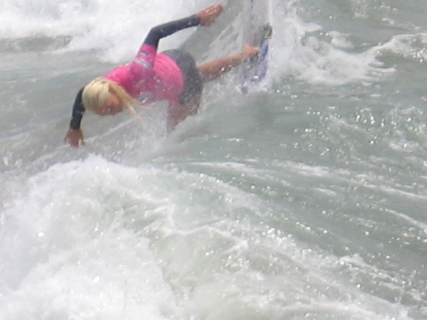 Tatiana plunges down the face of a Pacific Ocean breaker like Supergirl!