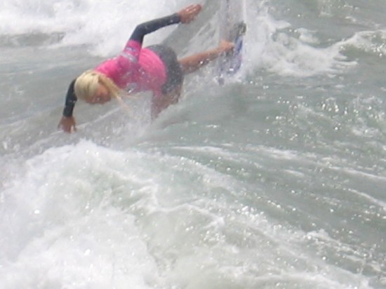 Tatiana plunges down the face of a Pacific Ocean breaker like Supergirl!