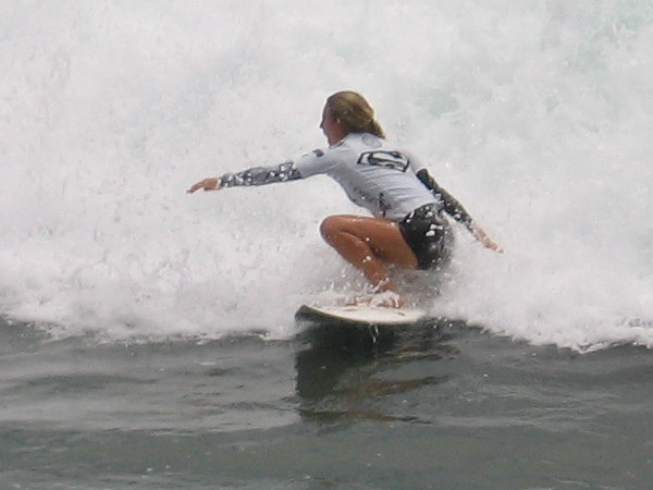 Supergirl is flying on a surfboard! (The Silver Surfer doesn't get to have all the fun!)