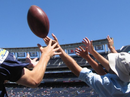A kicked football flies into the stands during the 2015 Chargers FanFest.
