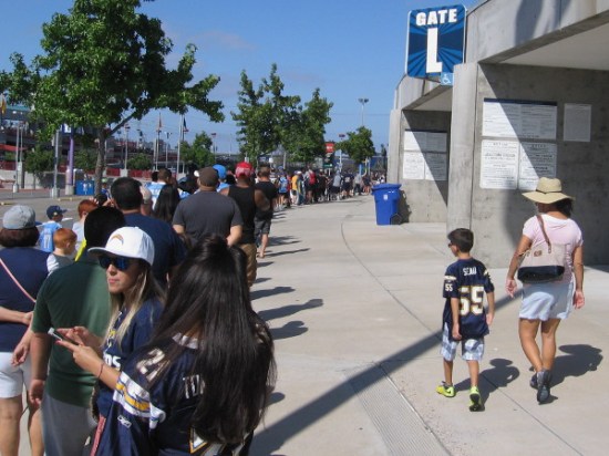 Thousands line up outside San Diego's Qualcomm Stadium to enjoy this year's Chargers FanFest. I saw many Seau jerseys being worn today.