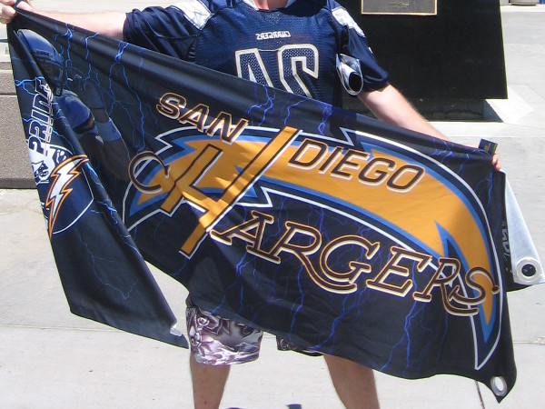 Save Our Bolts advocate holds up a San Diego Chargers banner for my camera. There's a chance the NFL team will soon leave San Diego.