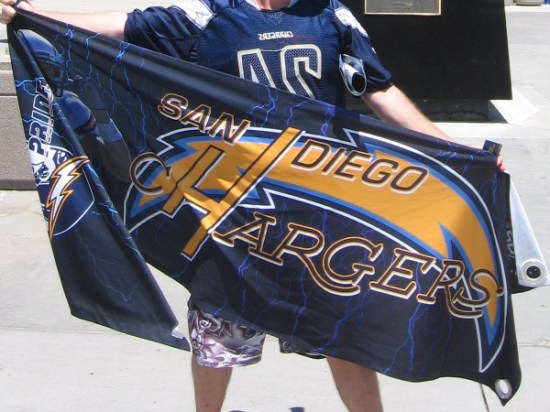 Save Our Bolts advocate holds up a San Diego Chargers banner for my camera. There's a chance the NFL team will soon leave San Diego.
