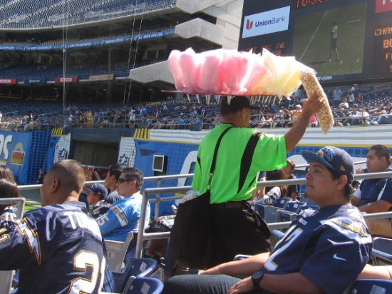 As Chargers fans watch football action on the field, vendors circulate with cotton candy, lemonade and other treats.