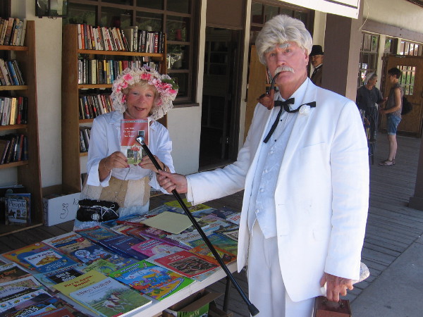Mark Twain uses his cane to point out his classic novel The Adventures of Tom Sawyer. Many 19th century authors and fictional characters were seen walking about during TwainFest.