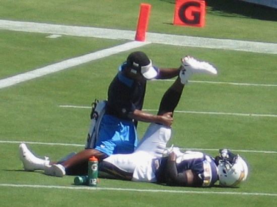 Stretching out this valuable player's leg muscles involves professional sports medicine expertise.