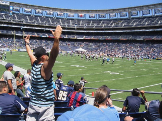 An animated fan in the stands gestures during the preseason practice session.