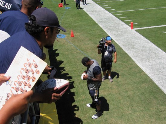 Practice is over, and King Dunlap signs autographs for thrilled fans in the stands.