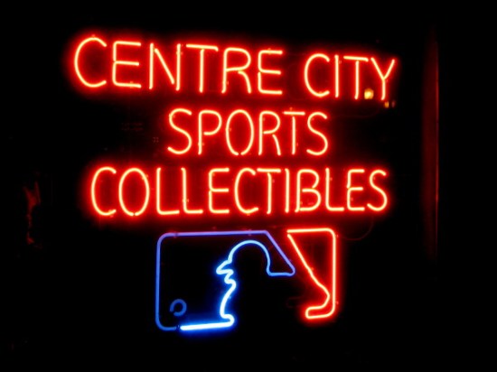 Cool neon sign in shop window of Centre City Sports Collectibles.