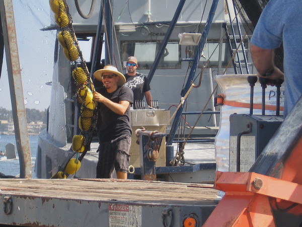 Working with a smile on a sunny summer Saturday on San Diego's busy Embarcadero.