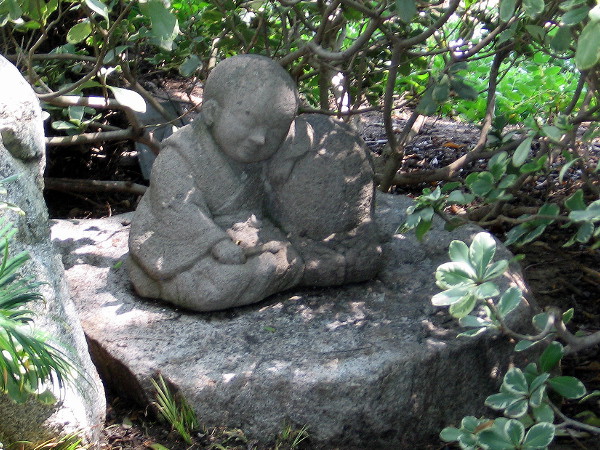 This small sculpture of a child is a mystery. One of the groundskeepers told me that. It might be a young Buddha, or an infant who tragically died. No one seems to know its history.