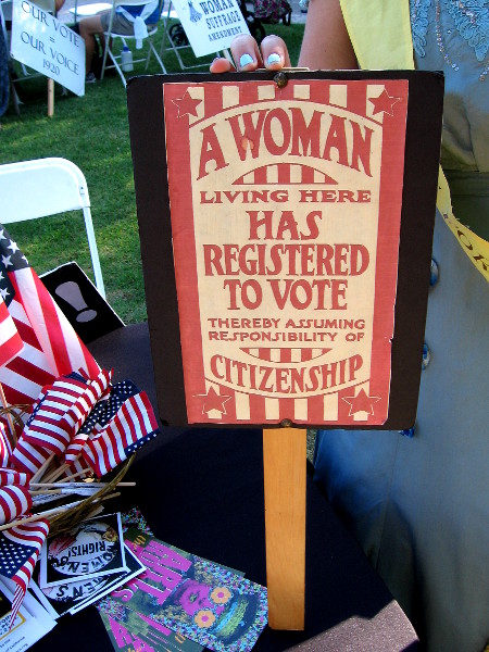Historical sign proclaims a woman living here has registered to vote thereby assuming the responsibility of citizenship.