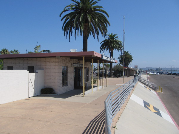 It's a quiet weekday morning outside the Outboard Boating Club of San Diego's building near the Shelter Island boat ramp. A nearby flagpole is empty.
