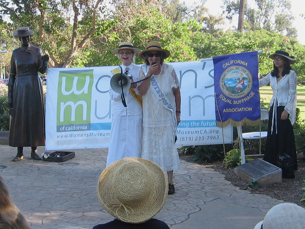 The woman with the microphone portrayed American suffragist and social activist Elizabeth Cady Stanton, who wrote many of Susan B. Anthony's speeches.