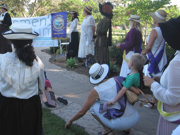 Many wore historical sashes, hats and costumes to commemorate suffragettes and leaders who have fought for equal women's rights.