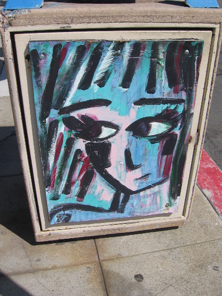 A female face painted on a La Jolla garbage container.