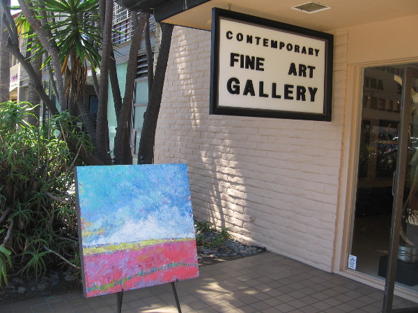 A canvas out on public display in front of the Contemporary Fine Art Gallery in the central business area sometimes called Village of La Jolla.