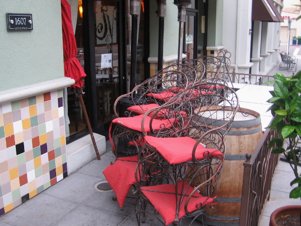 An umbrella and chairs that will soon be arranged for casual alfresco dining.