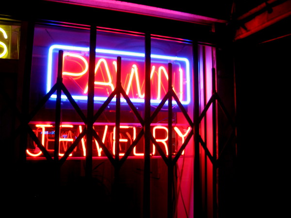 Classic neon signage is often seen in pawn shop windows.