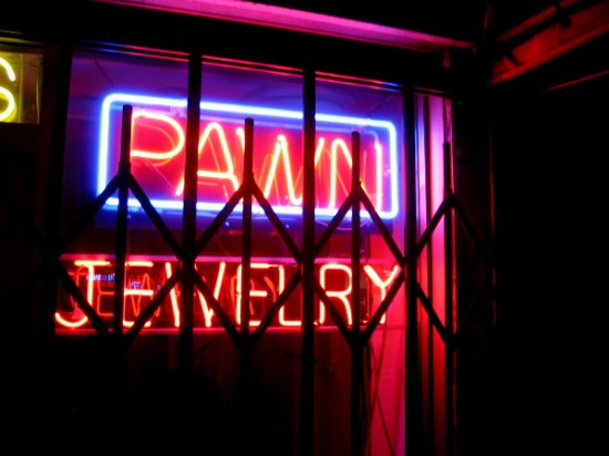Classic neon signage is often seen in pawn shop windows.