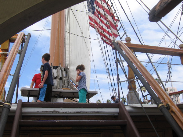 Kids walk up onto Star of India's high poop deck. Perhaps the eyes of youth, probing the horizon, can discern the strange wonder of Moby Dick.