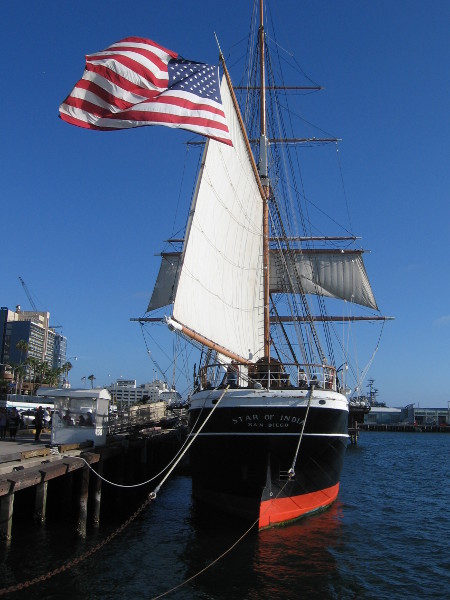 The stern of our beautiful Star of India. A large American flag billows in the sea breeze.