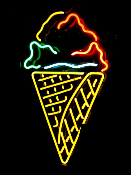An ice cream cone creatively rendered using neon.